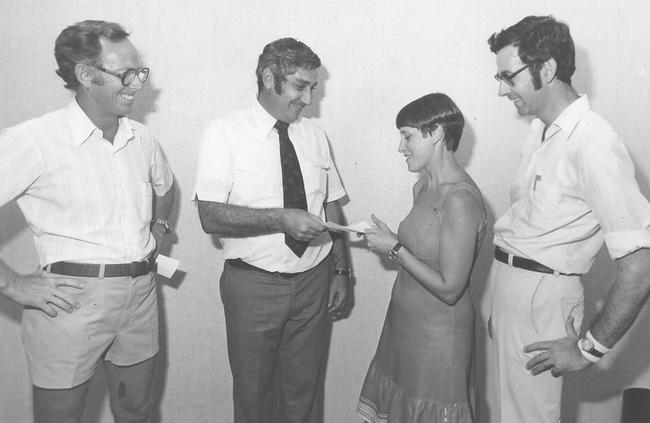 Ray Norman (left) looks on as the NT Minister Elect for Youth, Sport and Recreation, Nick Dondas, presents a $16,750 cheque to the Darwin Youth Refuge chairperson Val Blinco.