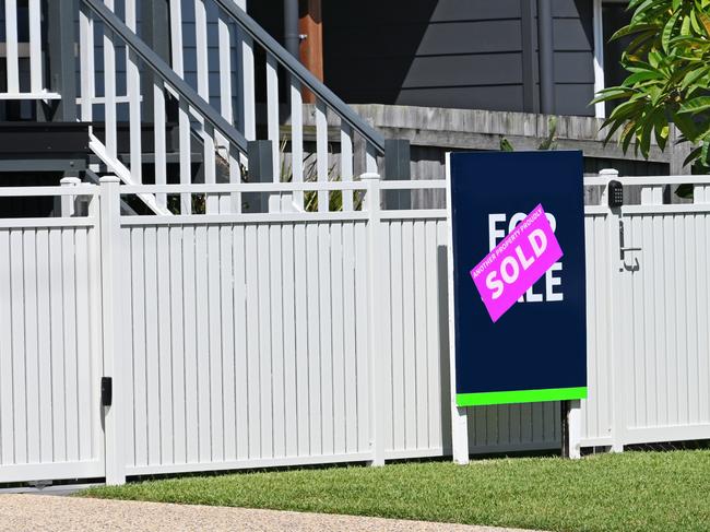 For sale sign in front of a property with a sold sticker over the top