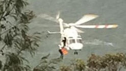 A woman, 55, from Avalon, had to be winched on to the NSW Ambulance helicopter after she fell and hit her head at an isolated ex-military bunker on West Head, in the Ku-ring-gai Chase National Park on Saturday. Picture: Belrose Rural Fire Brigade