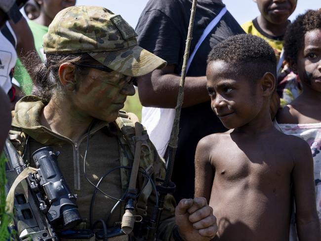 Australian Army officer Lieutenant Samantha May from the 3rd Battalion, The Royal Australian Regiment, with local community members during Exercise Wantok Warrior 2023, Papua New Guinea.