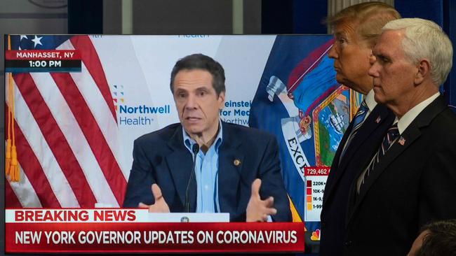 Andrew Cuomo gives a press conference as Donald Trump and Mike Pence look on. Picture: AFP.