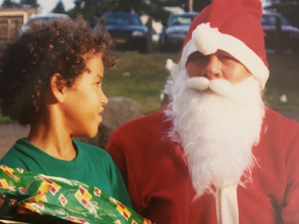 Sydney Kings star forward Xavier Cooks with Santa as a kid. Picture: Supplied.