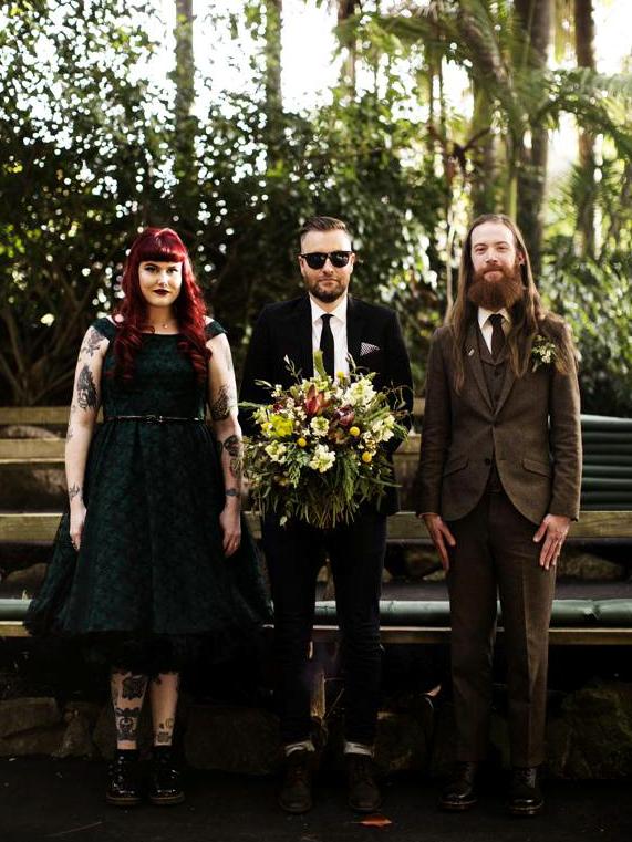 Newlyweds Simon and Jess and more than happy to have Paul stand in for their wedding portrait. Photo: Kristina Wild