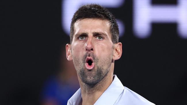 Serbia's Novak Djokovic reacts on a point against France's Adrian Mannarino during their men's singles match on day eight of the Australian Open tennis tournament in Melbourne on January 21, 2024. (Photo by David GRAY / AFP) / -- IMAGE RESTRICTED TO EDITORIAL USE - STRICTLY NO COMMERCIAL USE --