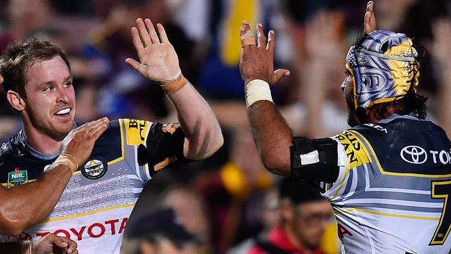 Michael Morgan celebrates with Johnathan Thurston after scoring a try.