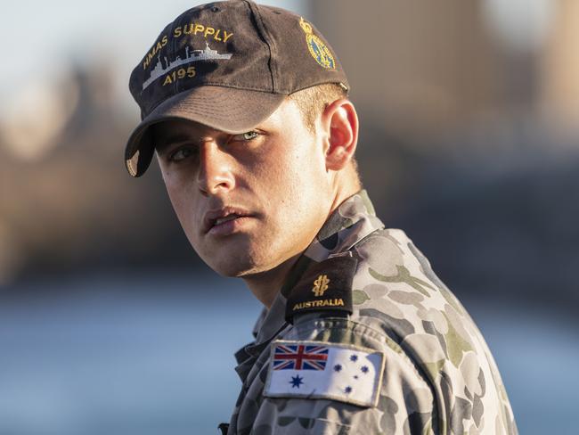 Able Seaman Boatswain’s Mate Damon Lewoshko watches on as HMAS Supply departs Fleet Base East in Sydney for its ceremonial homeport, Eden, NSW.