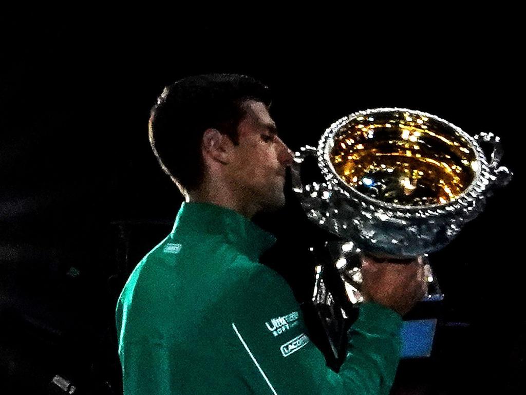 Novak Djokovic of Serbia poses for photographers with the Norman Brookes Challenge Cup after winning the men's singles final on day 14 of the Australian Open tennis tournament at Rod Laver Arena in Melbourne, Sunday, February 2, 2020. (AAP Image/Scott Barbour) NO ARCHIVING, EDITORIAL USE ONLY