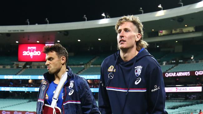 Injured Bulldogs Sam Lloyd and Aaron Naughton walk the sidelines at the SCG.