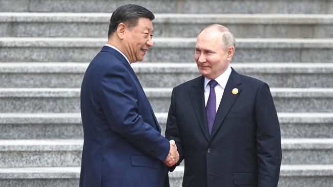 Xi Jinping and Vladimir Putin shake on it in front of the Great Hall of the People in Tiananmen Square in Beijing on Thursday. Picture: AFP