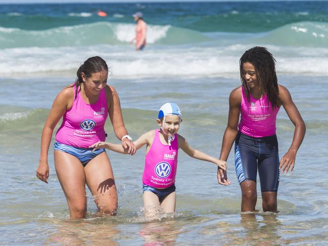 With his heroes in the surf.