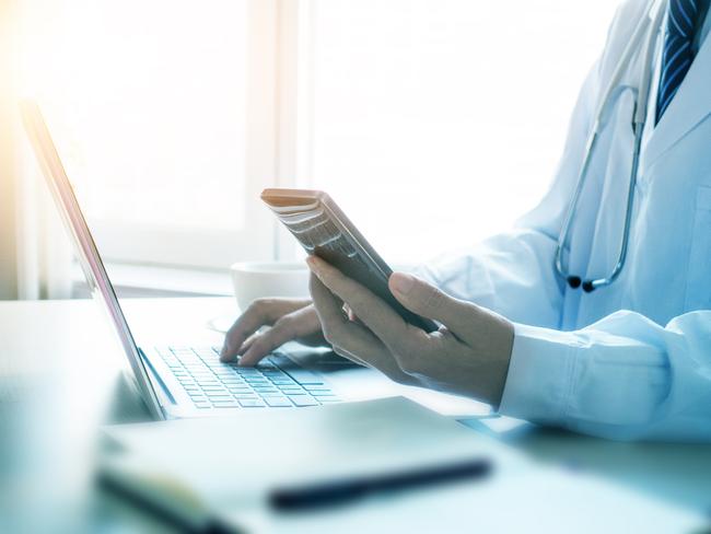 Doctor using smartphone in office