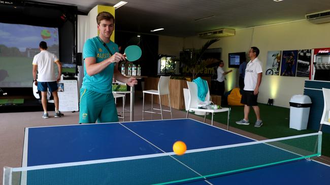 Athlete Jacob Schmid plays ping pong as Athletes gather at the "Edge".