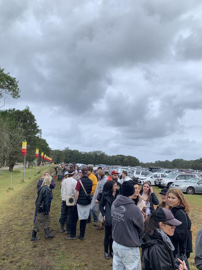 Splendour in the grass ticket holders line up to be shuttled to the event, however many are choosing to go home instead after Fridays event has been cancelled. Picture: Matt Gazy