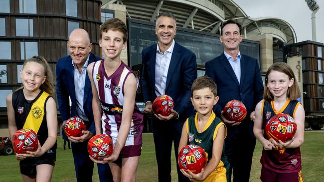 SANFL CEO Darren Chandler, Premier Peter Malinauskas and AFL CEO Andrew Dillon with young local footballers Sassinia, Blake, Ellis and Emma. Picture: Mark Brake/Getty Images