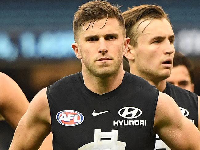 Marc Murphy of the Blues (second from right) leads his team from the ground after the Round 9 AFL match between the Carlton Blues and the Melbourne Demons at the MCG in Melbourne, Sunday, May 20, 2018. (AAP Image/Julian Smith) NO ARCHIVING, EDITORIAL USE ONLY