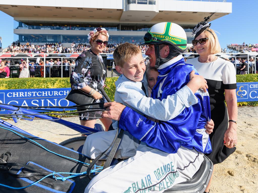 Blair Orange receives a hug from his son Harrison after his winning drive. Getty Images