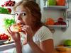 Picture: iStock
woman eats sweets at night to sneak in a refrigerator