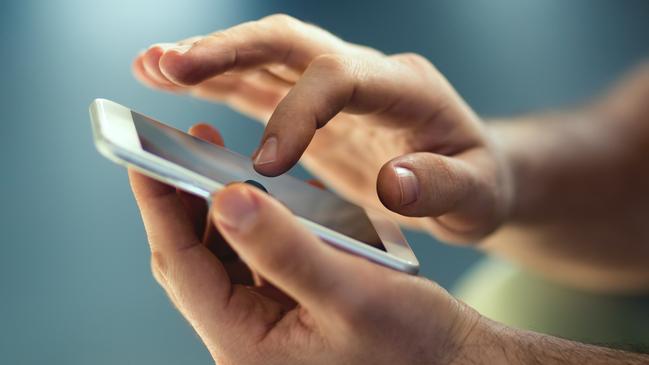 File photo of a man typing on his phone.