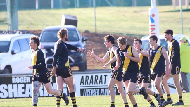 Woorndoo Mortlake president Grant Cameron, second left, celebrates the win with team mates after the win. Picture: Tracey Kruger.