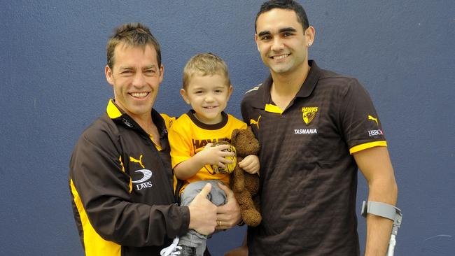 Hawthorn coach Alastair Clarkson welcomes a Shaun Burgoyne, on crutches, and son Ky to the Hawks in 2009.