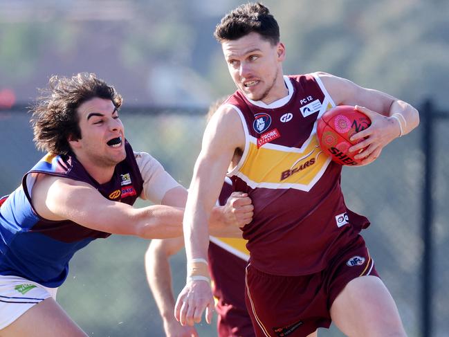 Northern Football League (NFL): Lower Plenty v Banyule at Montmorency Park. Sam Paterson of Lower Plenty in action.  Ben Paterson (6) of Lower Plenty is tackled by Adam Carafa (25) of Banyule.10 July 2021.Picture : George Salpigtidis