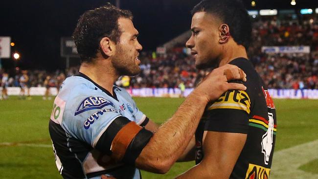 PENRITH, AUSTRALIA - JULY 23: Dale Finucane of the Sharks looks at the ear of Stephen Crichton of the Panthers after the  round 19 NRL match between the Penrith Panthers and the Cronulla Sharks at BlueBet Stadium on July 23, 2022, in Penrith, Australia. (Photo by Matt Blyth/Getty Images)