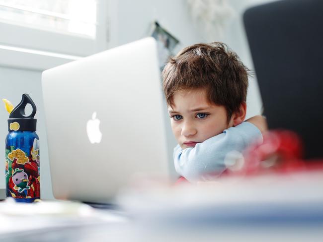 Phoenix Crawford does school work on a laptop at home in Sydney earlier this month. Picture: Getty Images