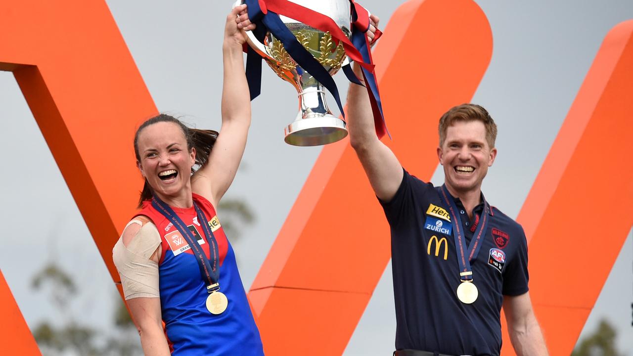 Head coach Mick Stinear and Daisy Pearce of the Demons hold the trophy aloft after winning the AFLW Grand Final match between the Brisbane Lions and the Melbourne Demons at Brighton Homes Arena on November 27, 2022 in Brisbane, Australia. (Photo by Matt Roberts/AFL Photos/Getty Images)