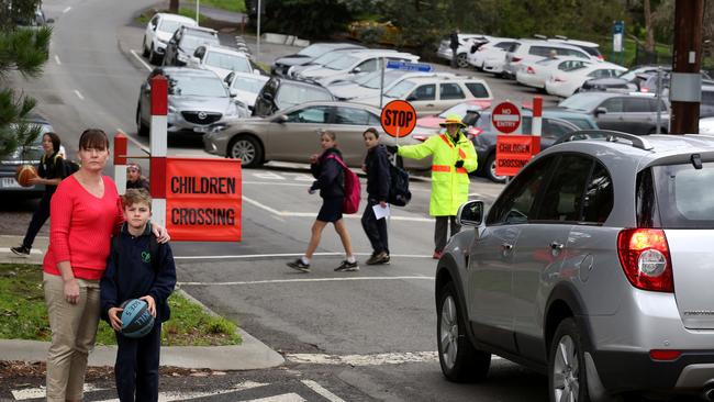 Lesley Grimley and son Chris outside Wonga Park Primary, where a surge in enrolments has created a traffic problem. Picture: Stuart Milligan