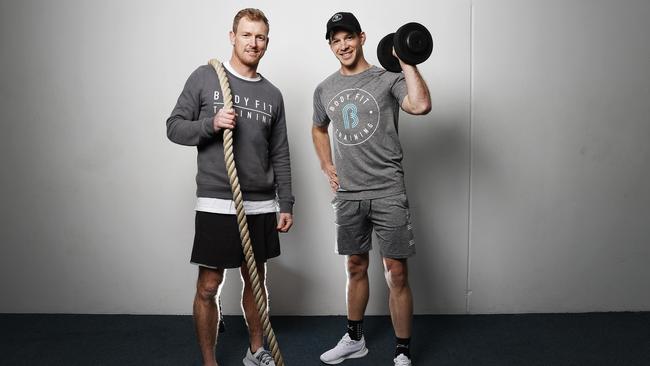 Former Tasmanian and Australian cricket player turned selector George Bailey and current Australian Test cricket captain Tim Paine have teamed up with former AFL player Nick Riewoldt in securing the Tasmanian rights to start up Body Fit Training. Picture: Zak Simmonds