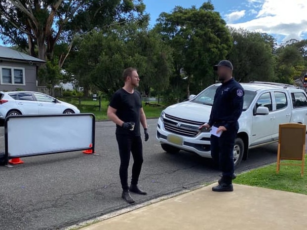 Fahrenheit Cafe owner Logan Dart talking to a council ranger who threatened him with $900 fines for his drive-through coffee bay at East Gosford. Picture: supplied