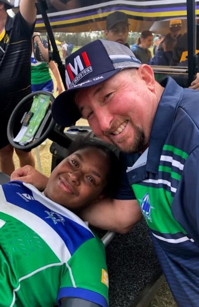 The Cathedral College girls' coach Scott Peters with injured player Harmonie Fauid, who broke her leg in the team's Confraternity Shield grand final win.