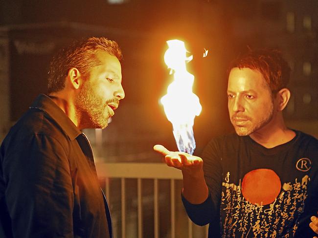 Cyril Takayama (in a David Blaine mask) demonstrates his fire hand trick for David Blaine. Picture: National Geographic/Dana Hayes