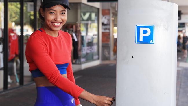 After the appearance of the parking meter fairy on Cairns Streets, there have been renewed calls to introduce a formal group to top up parking tickets and avoid fines. Josephine Tuah pays for parking along Grafton Street before getting lunch at a cafe. Picture: Brendan Radke