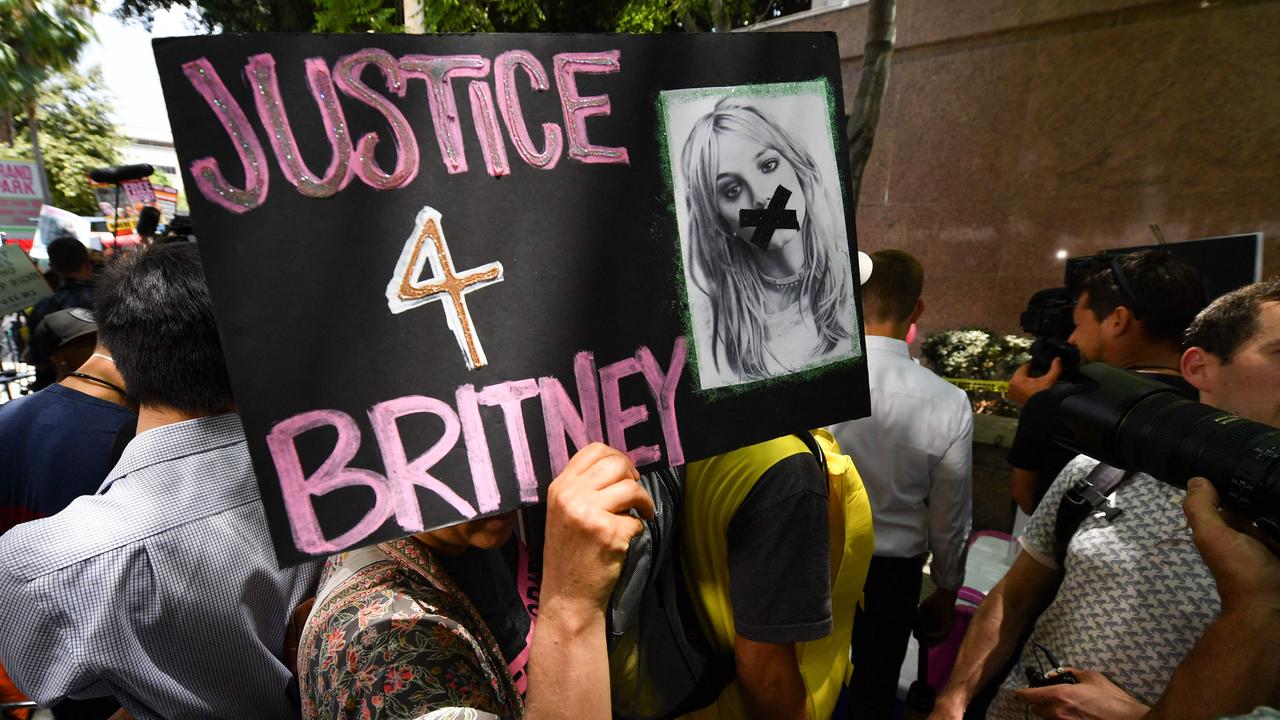 A fan holds a poster of Britney with her mouth taped shut as supporters gather outside the Los Angeles County Courthouse in Los Angeles. Picture: Robyn Beck/AFP