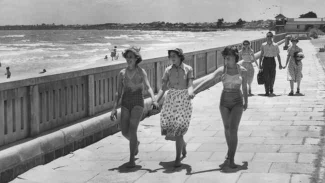 Returning from a dip in the 1950s. Love the vintage bathing suits. Picture: HWT Argus Collection