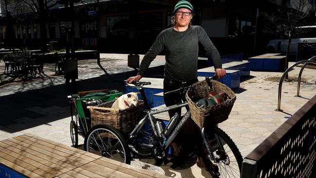 Alex carries his three-legged dog Doofa around on the back of his bike.