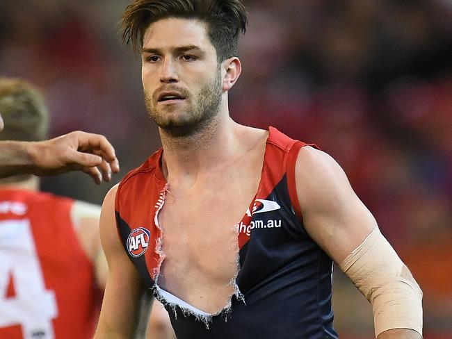 Dane Rampe of the Swans (second from left) and Cameron Pedersen (left) and Tomas Bugg of the Melbourne Demons are seen during the Round 15 AFL match between and the Melbourne Demons and the Sydney Swans at MCG in Melbourne, Friday, June 30, 2017. (AAP Image/Julian Smith) NO ARCHIVING, EDITORIAL USE ONLY