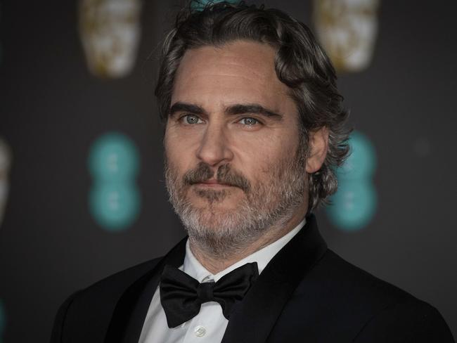 Actor Joaquin Phoenix poses for photographers upon arrival at the Bafta Film Awards, in central London, Sunday, Feb. 2 2020. (Photo by Vianney Le Caer/Invision/AP)