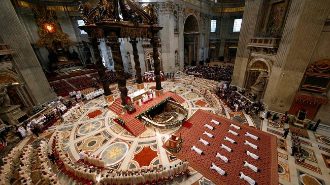 Newly ordained priests lie on the floor as Pope Francis leads a mass in Saint Peter's Basilica at the Vatican. Picture: