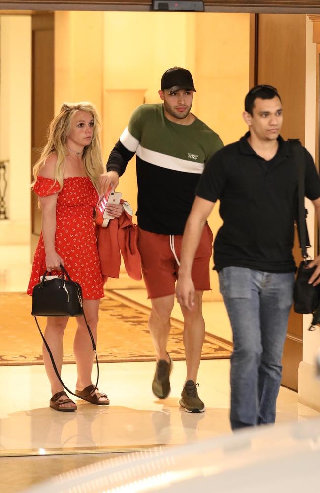 Britney looks forlorn with boyfriend Sam Asghari (centre). Picture: BACKGRID