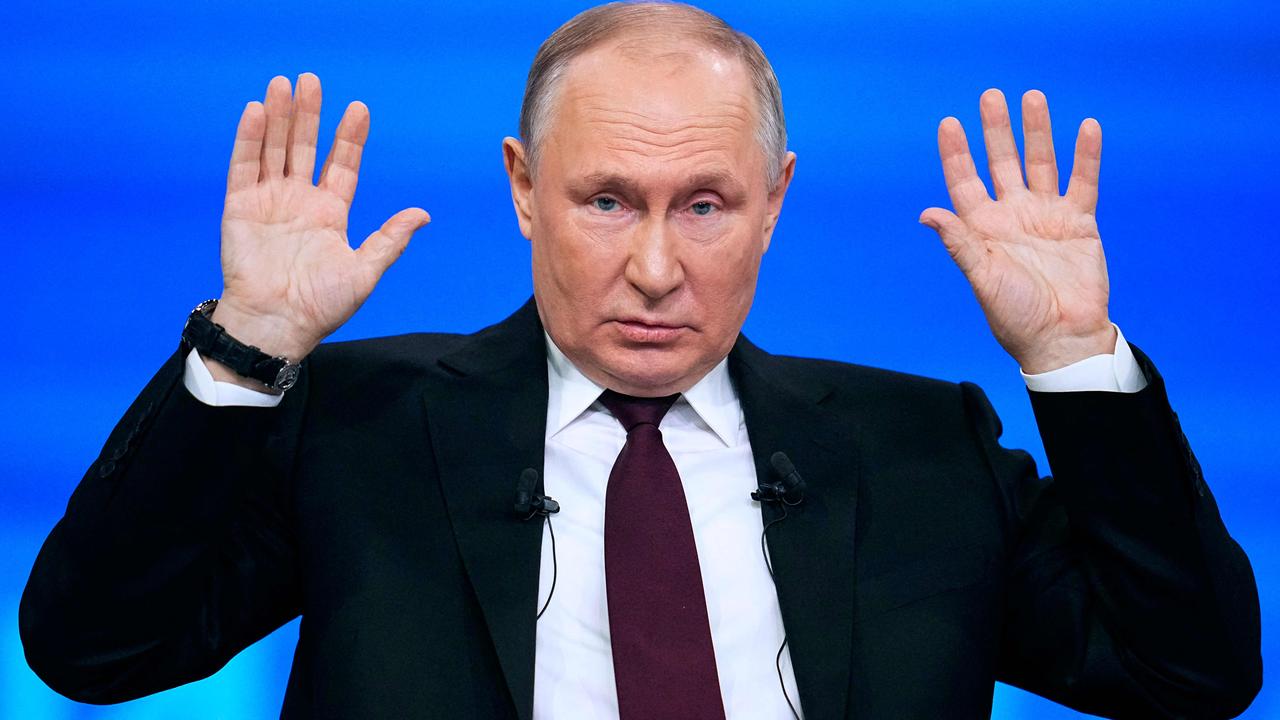 Russian President Vladimir Putin holds his hands up during his year-end press conference. Picture: Alexander Zemlianichenko/AFP
