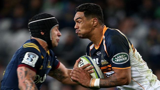 Chance Peni of the Brumbies about to be met in the tackle by Rob Thompson of the Highlanders on Saturday night.