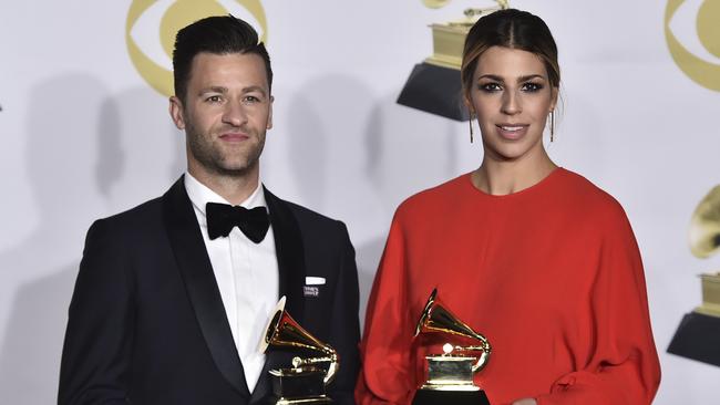 Ben Fielding, left, and Brooke Ligertwood, of Hillsong Worship, pose in the press room their Grammys.