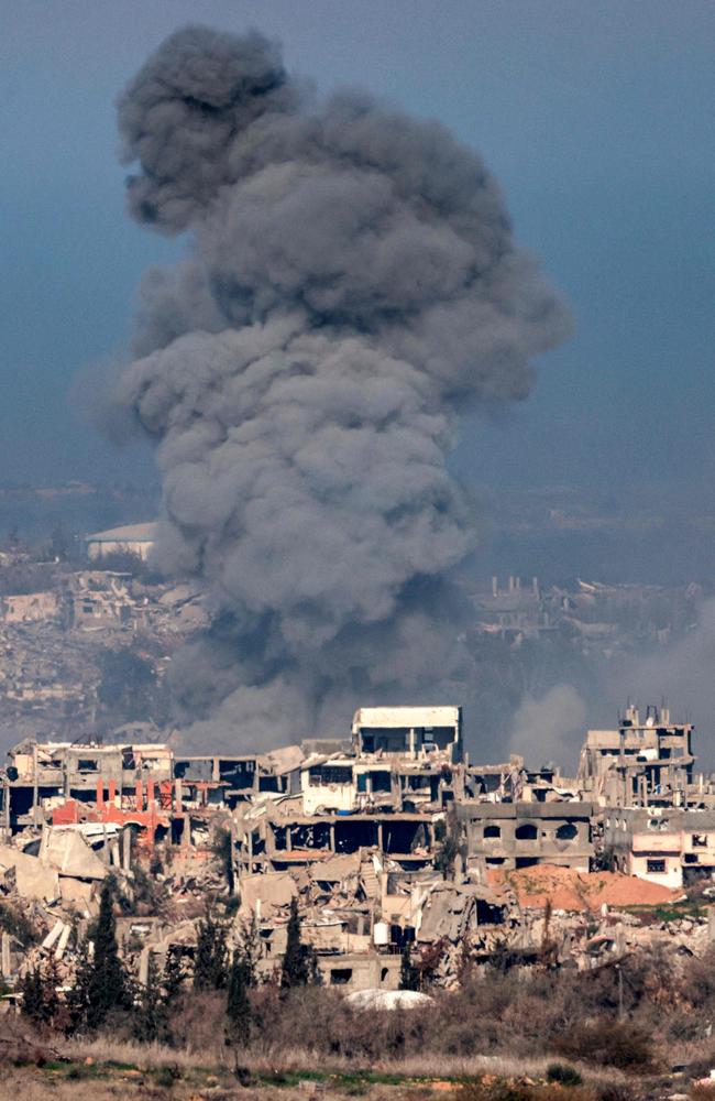 This picture taken from the Israeli side of the border with the Gaza Strip shows a smoke plume rising from explosions above destroyed buildings in the northern Gaza Strip on January 13. Picture: Menahem Kahana/AFP