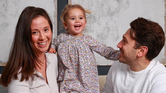 Daily Telegraph. 05, July, 2022.**For SMARTdaily cover story about investing for children**Rhodie and Alex Bedwani, with their daughter, Audrey, 2, at home, in Darlinghurst, today. Picture: Justin Lloyd.