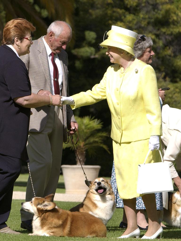 Queen Elizabeth II meets the Adelaide Kennel Club corgi owners on the lawn of Government House during her tour of Australia in 2002. Picture: Fiona Hanson – PA Images/PA Images via Getty Images