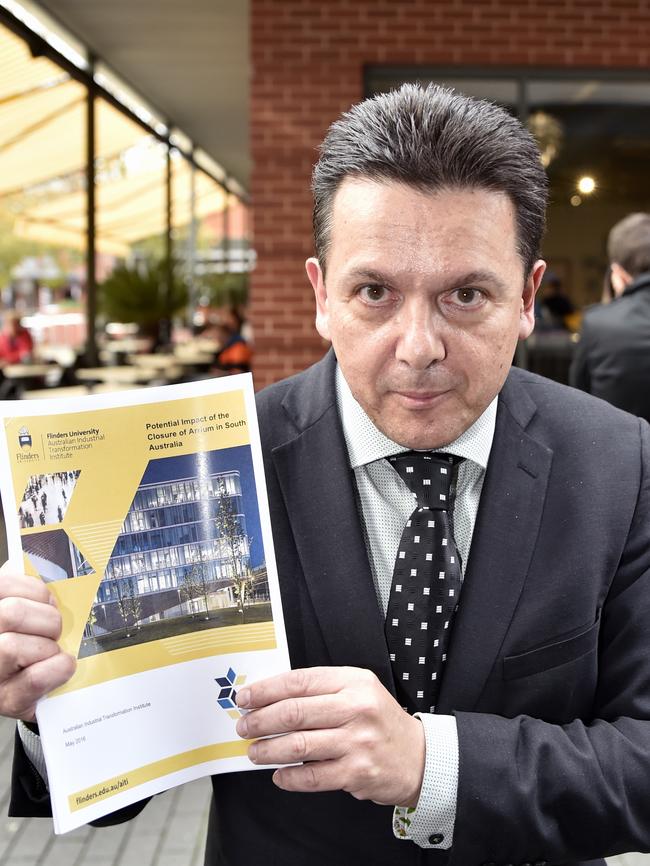 Senator Nick Xenophon holds up a report detailing the potential impact of the closure of Arrium in South Australia. AAP Image/David Mariuz