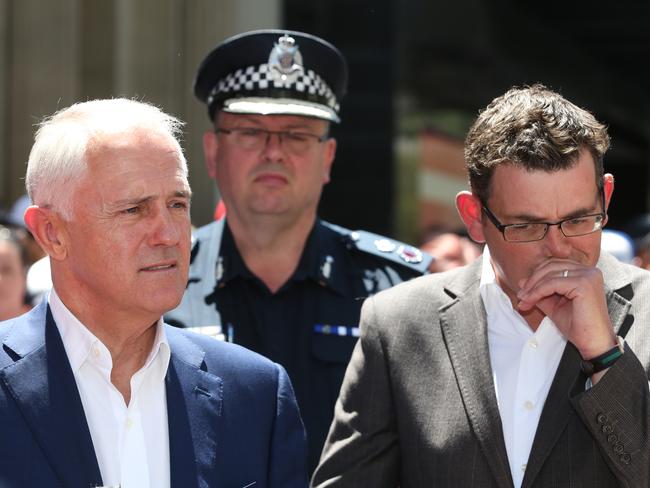 Prime Minister Malcolm Turnbull, Premier Daniel Andrews Victoria Police Commissioner Graham Ashton (rear) at the site of the Bourke St tragedy. Picture: David Crosling