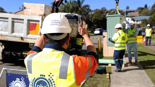 An NBN contractor installs a fibre-to-the-node connection in Newcastle, NSW.